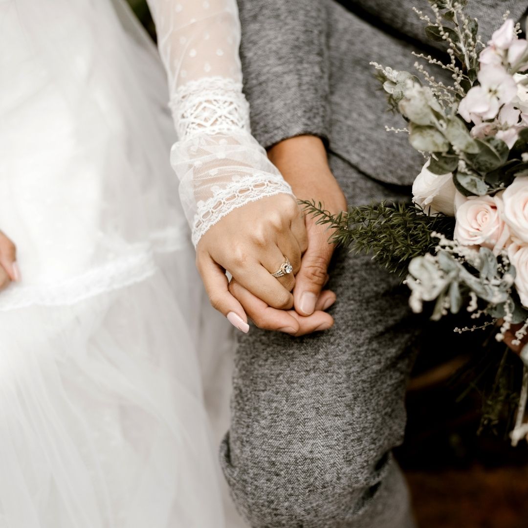 a bride and a groom holding hands